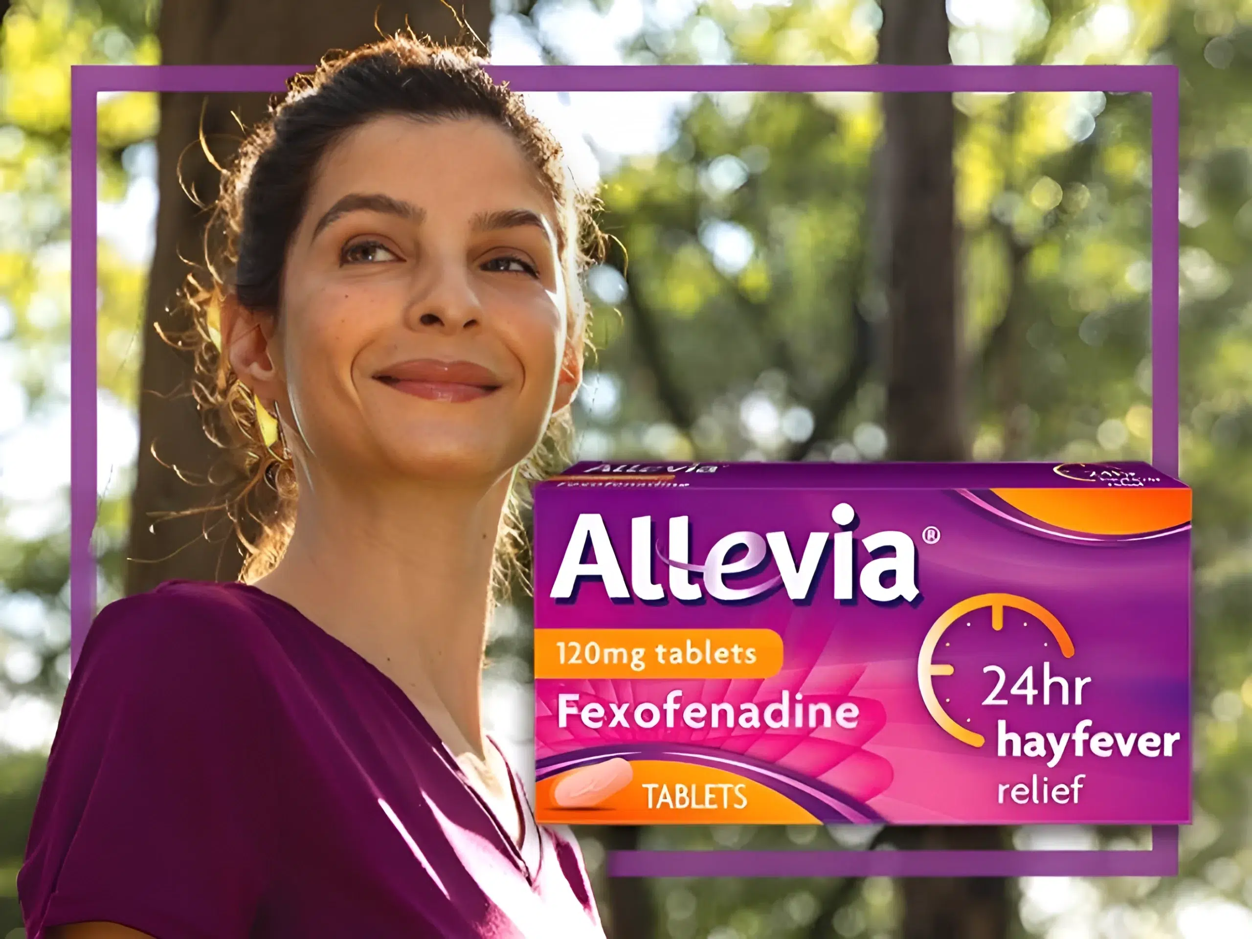A woman smiling in the woods next to a packet of Sanofi Allevia hayfever tablets
