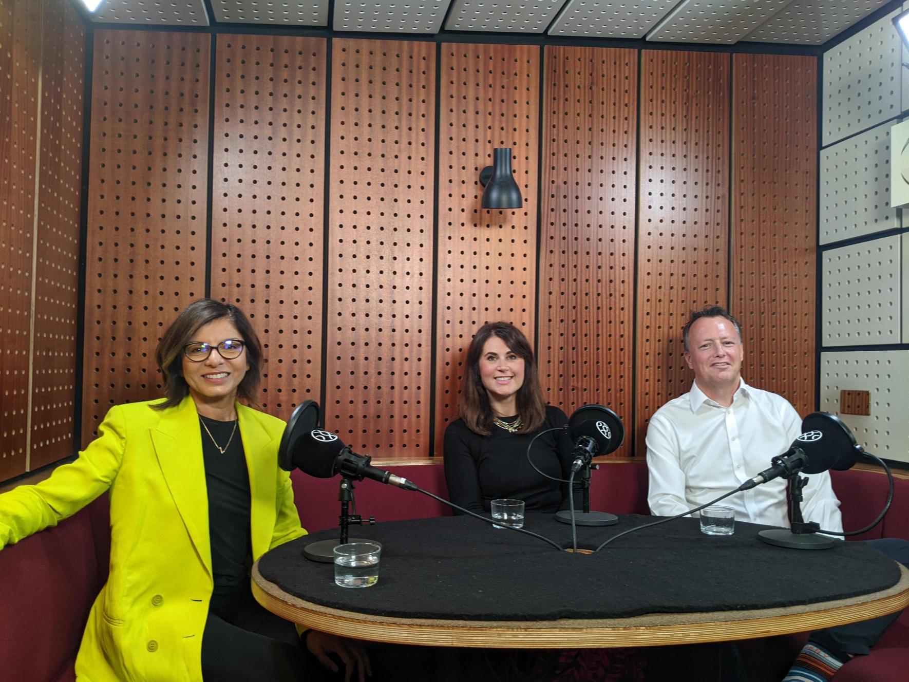 Three people from Ceuta Group sit in a podcast recording studio around a table smiling