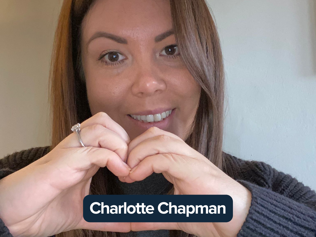 Charlotte Chapman making a heart with her hands.