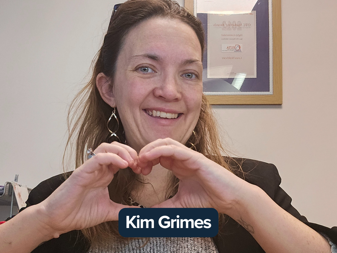 Kim Grimes making a heart with her hands